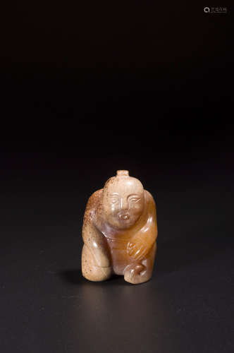 A redish-brown jade figurine