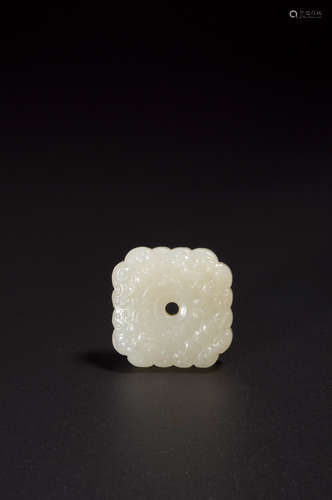 A beast face patterned white jade button