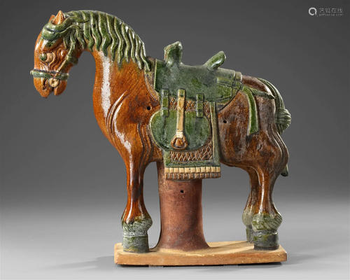 A CHINESE GREEN AND BROWN GLAZED HORSE, MING DYNASTY (1368 -...