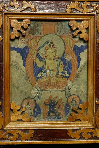 Old Mongolian Thangka inside an ornate old frame. Frame