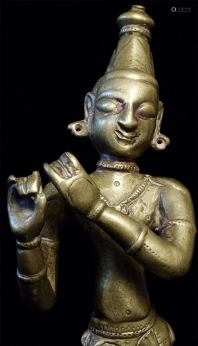 Antique bronze Folk style Krishna playing his flute.