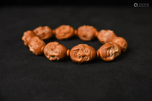 Set of 12 very finely carvedÂ Olive or other fruit pits.