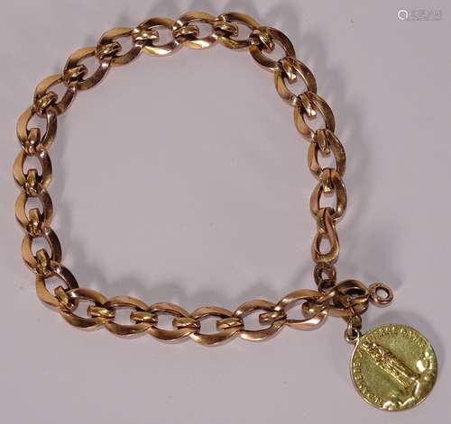 BRACELET en or rose orné d'une médaille religieuse "Not...