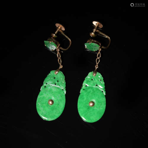 A pair of Chinese jadeite earrings with 14 karat gold settin...