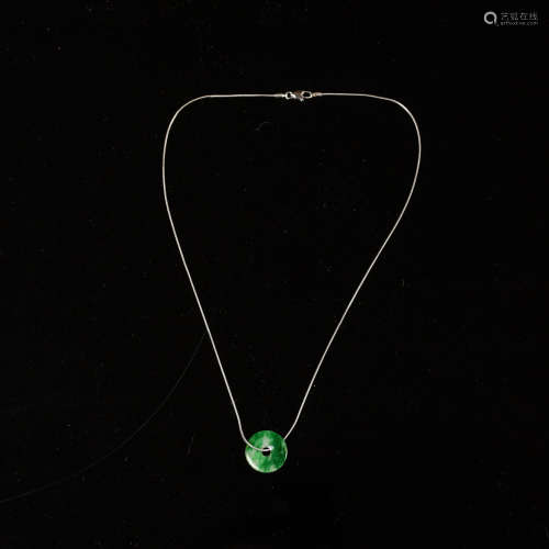 A Chinese jadeite bi disc on fourteen karat white gold neckl...