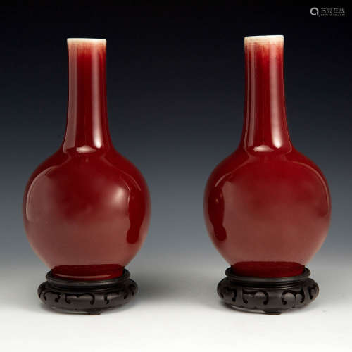 A pair of Chinese red-glazed vases with wood stands  Late 19...