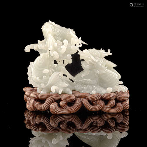 A Chinese celadon jade carving of a turtle dragon and two ca...