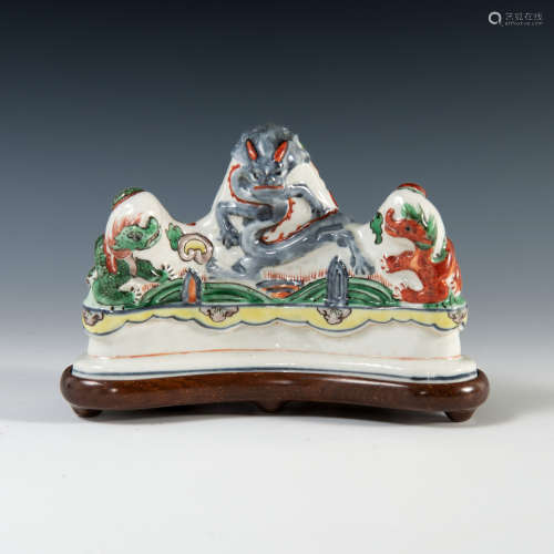 A Chinese blue underglazed wucai brush rest featuring dragon...