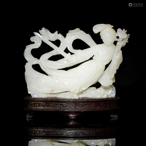 A Chinese white jade carving of a beauty holding a sword and...