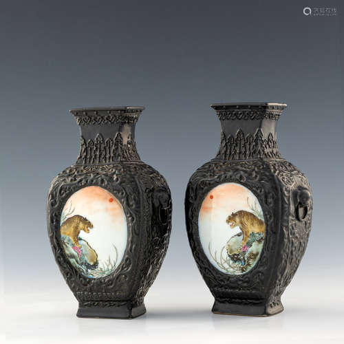 A pair of Chinese black ground ceramic vases with famille ro...