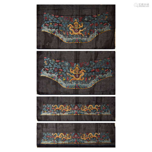 A group of four Chinese black ground dragon robe raw materia...