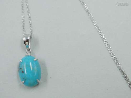 Pendentif en or blanc 18k retenant une turquoise en cabochon...