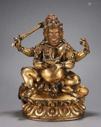 A gilding copper four-armed Mahakala statue