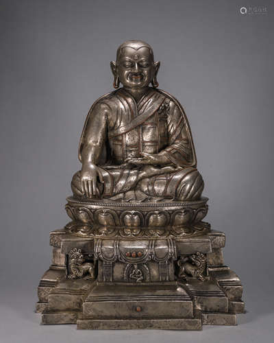 A silver-inlaid copper Tibetan buddha statue