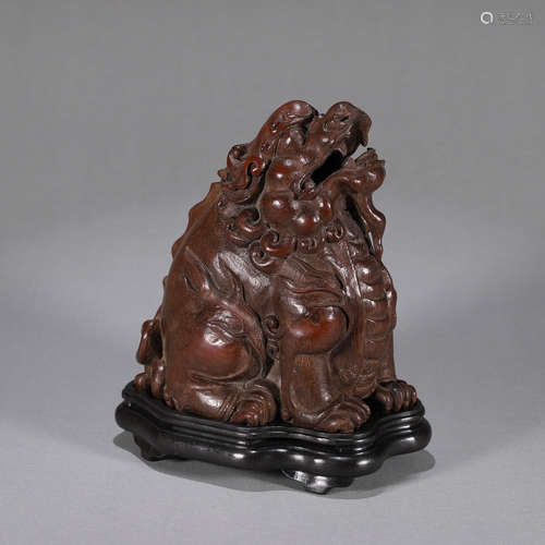 A wood carved suanni incense burner