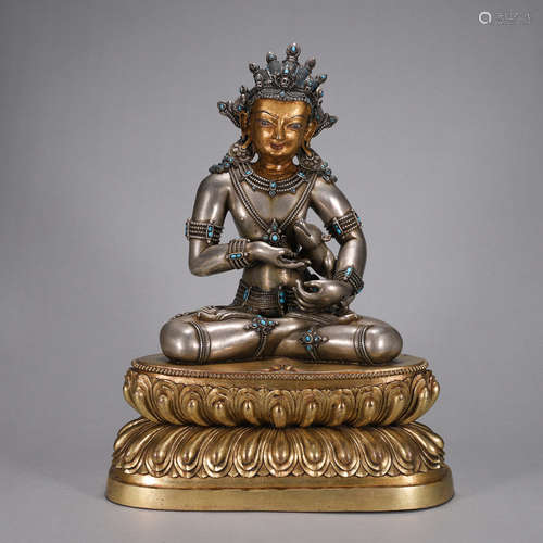 A silver Mahavairocana buddha statue