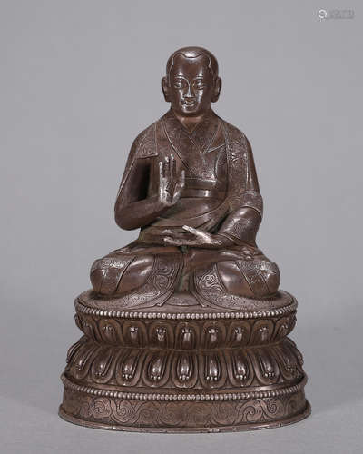 A silver Tibetan buddha statue