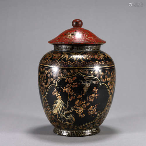 A gilt bird and flower patterned lacquer jar