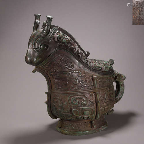 A taotie patterned bronze goat head pot