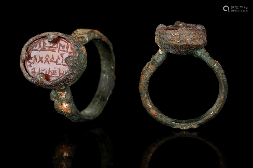 SELJUK BRONZE RING WITH CARNELIAN INTAGLIO GEM WITH CALLIGRA...