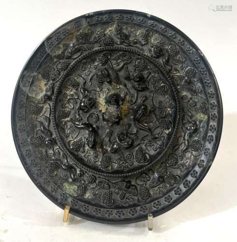 A Chinese Bronze Mirror with Protruding Central Animal &...