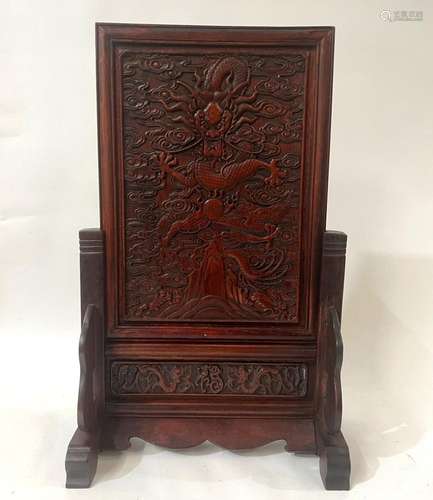 A Chinese Carved Rosewood Table Screen Depicting a Dragon Fl...