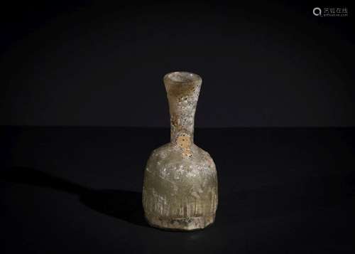 A POST SASANIAN MOULDED GLASS BOTTLE CIRCA 8TH-9TH CENTURY A...