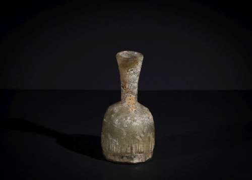 A POST SASANIAN MOULDED GLASS BOTTLE CIRCA 8TH-9TH CENTURY A...