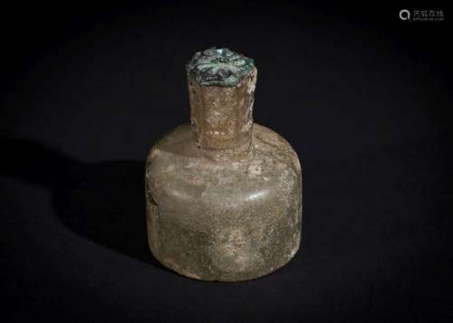 A LATE SASANIAN CUT GLASS BOTTLE WITH STOPPER, CIRCA 6TH CEN...