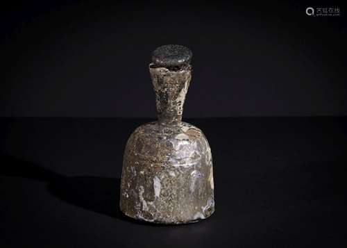 A SASANIAN CUT GLASS BOTTLE WITH THE ORIGINAL LID CIRCA 4TH-...