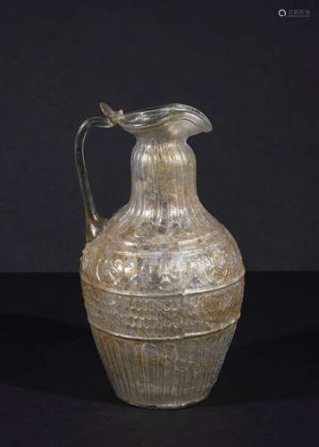 A ROMAN INTACT COLOURLESS GLASS JUG BY ENNION CIRCA 1ST CENT...