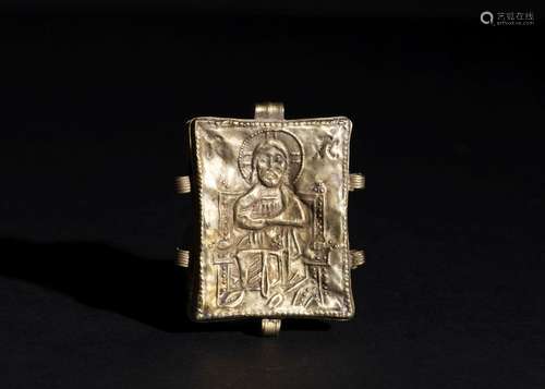 A GOLD PENDANT WITH A DEPICITON OF CHRIST WITH A LATIN INSCR...