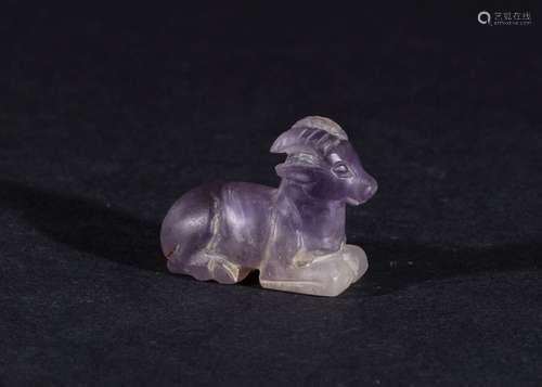 AN AMETHYST SEATED GOAT AMULET IN THE STYLE OF PTOLEMAIC PER...