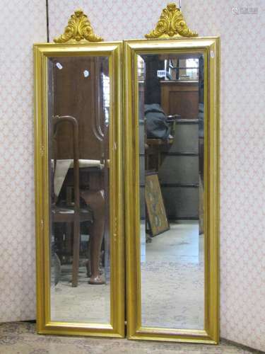 A pair of contemporary gilt framed mirrors with bevelled edg...