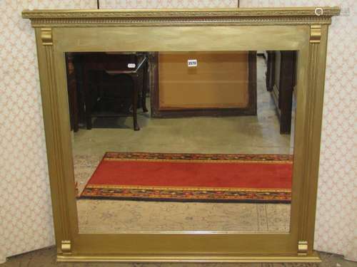 A rectangular overmantle mirror enclosing a bevelled edge mi...