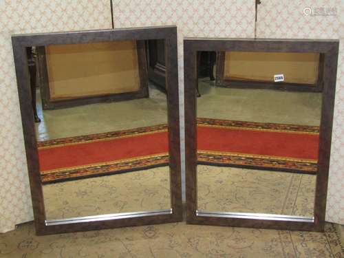 Two simple rectangular wall mirrors in metallic style frames...