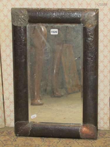 A 1920s hammered copper wall mirror, rectangular enclosing a...