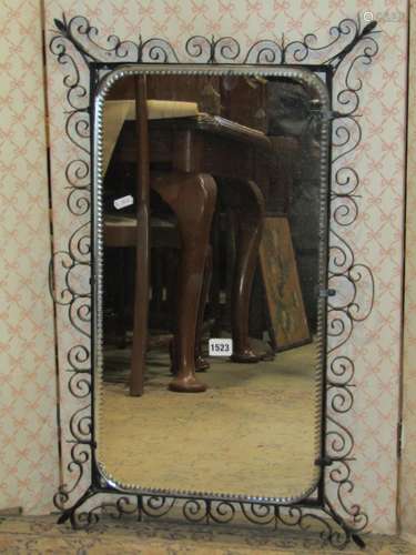 A decorative wall mirror rectangular with etched borders set...