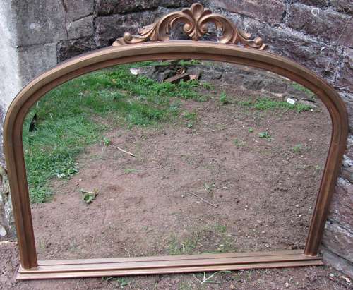 A Victorian arched overmantle mirror with bevelled edge plat...