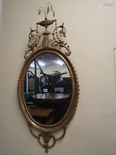 A good antique gilded wall mirror, the mirror plate of oval ...