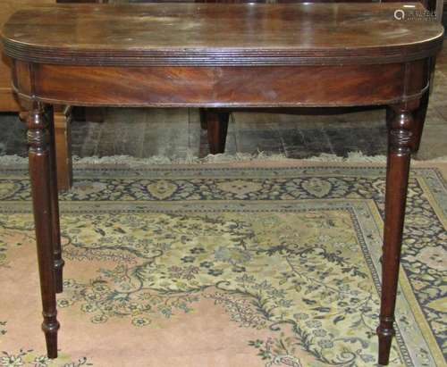 A Georgian mahogany D end fold over top tea table with reede...