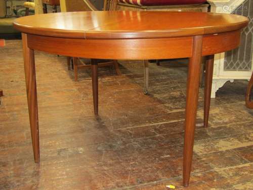 G plan teakwood extending dining table, circular when closed...