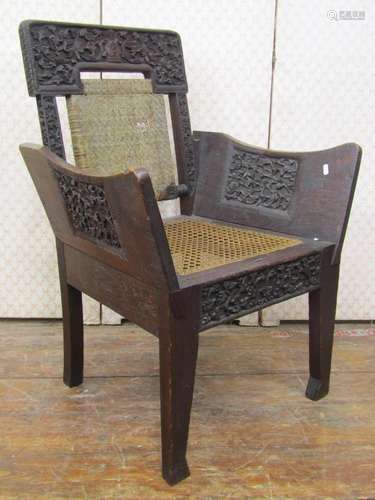 Antique Indonesian hardwood chair with carved framework, can...