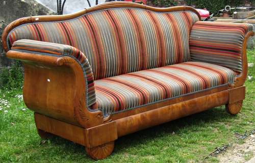 An early 19th century Biedermeier scroll end sofa, carved an...