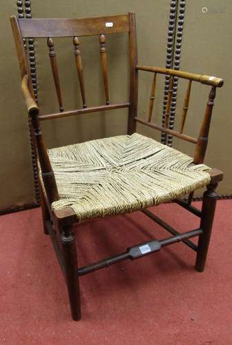 A 19th century beech and ash wood spindle back elbow chair w...