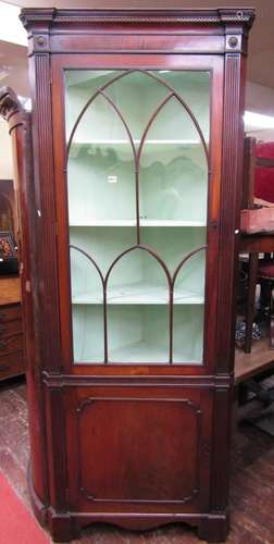 A Georgian mahogany free standing corner cupboard, the lower...