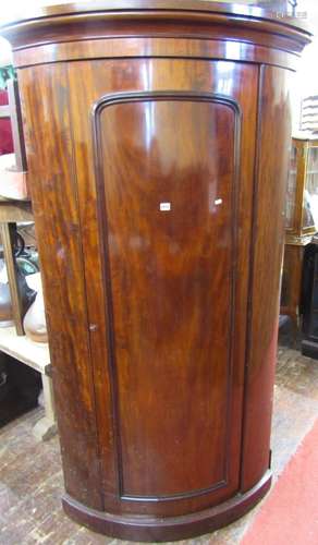 An unusual Victorian mahogany bow fronted hanging cupboard o...