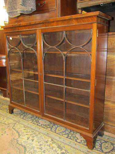 19th century mahogany cabinet enclosed by a pair of astragal...