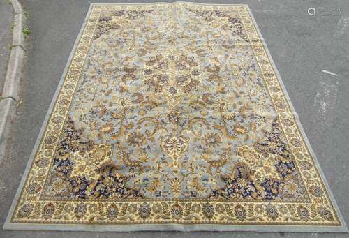 A large floral patterned carpet of Middle Eastern design wit...