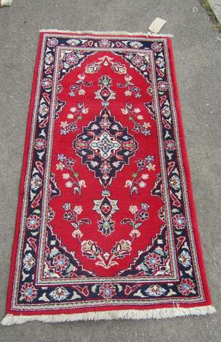 A small Tabriz mat with a central medallion and floral decor...